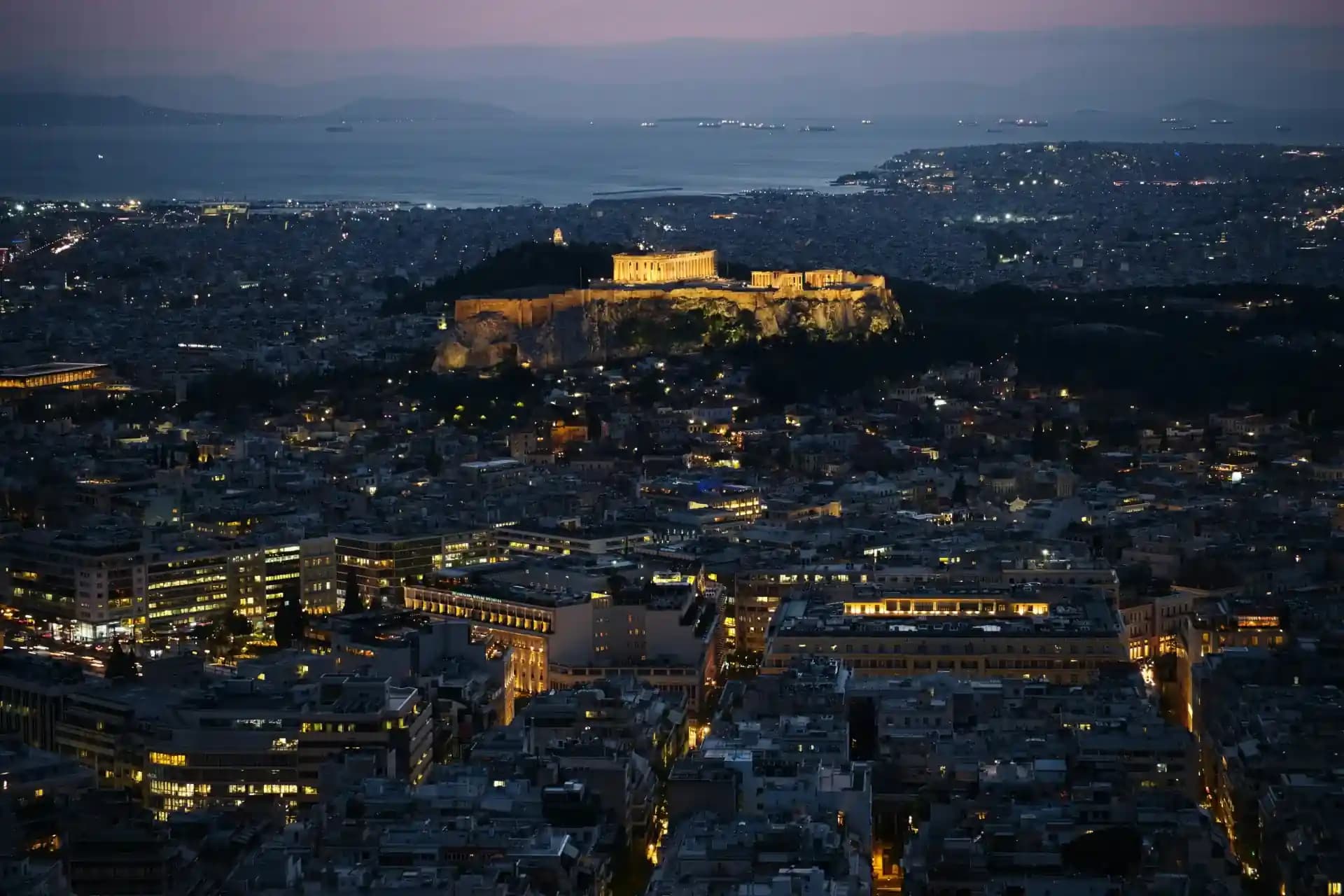 Panoramic night view of Athens Acropolis and city lights
